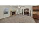 Spacious living room featuring a stone fireplace, coffered ceilings, and seamless access to the kitchen at 3777 Shady Maple Dr, Lithonia, GA 30038