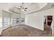 Carpeted main bedroom with tray ceiling and natural light at 3777 Shady Maple Dr, Lithonia, GA 30038