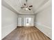 Carpeted main bedroom with tray ceiling and double door entrance at 3777 Shady Maple Dr, Lithonia, GA 30038