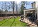 Spacious backyard featuring a patio, grill and shade trees at 411 Johnson Ct, Alpharetta, GA 30009