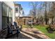 Landscaped backyard featuring a stone patio, grill, and outdoor seating at 411 Johnson Ct, Alpharetta, GA 30009