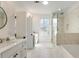 This stunning bathroom features tile flooring, a double vanity, a soaking tub, and a glass-enclosed shower at 411 Johnson Ct, Alpharetta, GA 30009