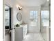 Well-lit bathroom featuring modern vanity, framed mirror, and a frameless glass shower enclosure at 411 Johnson Ct, Alpharetta, GA 30009