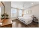 This bright bedroom features a ceiling fan, two sunny windows, and a side table with decorative lamps at 411 Johnson Ct, Alpharetta, GA 30009