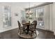 Bright dining area with hardwood floors, chandelier, and large windows at 411 Johnson Ct, Alpharetta, GA 30009