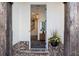 Warm entryway with brick flooring, decorative columns, and a glimpse of the interior staircase at 411 Johnson Ct, Alpharetta, GA 30009