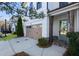 Inviting townhome with a two-car garage, brick accents, and a well-manicured lawn at 411 Johnson Ct, Alpharetta, GA 30009