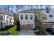 Charming townhome featuring a two-car garage and a neatly landscaped front yard on a sunny day at 411 Johnson Ct, Alpharetta, GA 30009