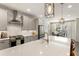 Bright kitchen with stainless appliances, light grey cabinets, and island seating at 411 Johnson Ct, Alpharetta, GA 30009