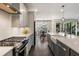 Beautiful kitchen with stainless appliances, quartz countertops, and hardwood flooring at 411 Johnson Ct, Alpharetta, GA 30009