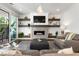 Bright living room with a modern fireplace, floating shelves, and sliding glass doors to the patio at 411 Johnson Ct, Alpharetta, GA 30009