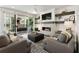 Comfortable living room with a modern fireplace, large TV, and seamless access to the outdoor patio at 411 Johnson Ct, Alpharetta, GA 30009