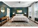 Stunning primary bedroom featuring a decorative rug, bedside tables and lamps, and a large sunny window at 411 Johnson Ct, Alpharetta, GA 30009