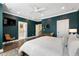 Comfortable primary bedroom featuring luxury vinyl flooring, a ceiling fan, a chair, and a door to the bathroom at 411 Johnson Ct, Alpharetta, GA 30009