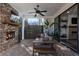 Covered brick patio with a fireplace, ceiling fan and comfortable seating at 411 Johnson Ct, Alpharetta, GA 30009