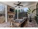 Relaxing covered patio with a brick fireplace, comfortable seating, and privacy fence at 411 Johnson Ct, Alpharetta, GA 30009