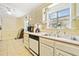 Kitchen showcases bright cabinets, stainless sink, and tile flooring at 4544 Ridgeview Dr, Powder Springs, GA 30127