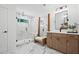 Modern bathroom with marble tile, glass shower, and wooden vanity at 130 Briargate Dr, Johns Creek, GA 30097