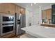 Spacious kitchen with an oversized island, stainless steel appliances, and stylish backsplash at 130 Briargate Dr, Johns Creek, GA 30097