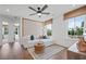 Bright living room with large windows, hardwood floors, and comfortable seating at 130 Briargate Dr, Johns Creek, GA 30097