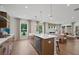 Open kitchen and living space with natural light, modern finishes, and hardwood floors at 130 Briargate Dr, Johns Creek, GA 30097