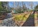 Backyard featuring stone stairway, landscaping, and mature trees at 3902 Sheldon Ne Dr, Atlanta, GA 30342