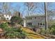 Backyard view of home featuring deck, mature trees, and landscaping at 3902 Sheldon Ne Dr, Atlanta, GA 30342