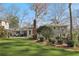 Backyard view of home featuring artificial turf, patio, mature trees, and deck at 3902 Sheldon Ne Dr, Atlanta, GA 30342