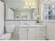 Well-lit bathroom with white tile, modern fixtures, and a large mirror over the sink at 3902 Sheldon Ne Dr, Atlanta, GA 30342
