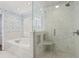 Bright bathroom features a glass enclosed shower and tub combination with bright white marble and fixtures at 3902 Sheldon Ne Dr, Atlanta, GA 30342