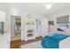 Bright bedroom with hardwood floors, a large window, and built-in shelving at 3902 Sheldon Ne Dr, Atlanta, GA 30342