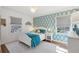 Stylishly decorated bedroom with blue accents, two windows, and hardwood floors at 3902 Sheldon Ne Dr, Atlanta, GA 30342