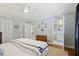 Bright bedroom with a ceiling fan, hardwood floors, and a view into an ensuite bathroom at 3902 Sheldon Ne Dr, Atlanta, GA 30342