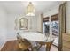 Cozy dining area with shiplap walls, stylish light fixture, and a window with views of the outdoors at 3902 Sheldon Ne Dr, Atlanta, GA 30342