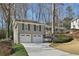 Two-story home featuring a gray brick exterior, white trim, and a two-car garage at 3902 Sheldon Ne Dr, Atlanta, GA 30342