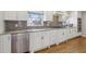 Well-appointed kitchen featuring white cabinets, stainless steel appliances, and granite countertops at 3902 Sheldon Ne Dr, Atlanta, GA 30342