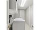 Functional laundry room with washer, dryer, overhead shelving, and tile floors at 3902 Sheldon Ne Dr, Atlanta, GA 30342