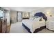 Spacious main bedroom with a large bed, patterned curtains, and neutral carpet at 3902 Sheldon Ne Dr, Atlanta, GA 30342