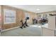 Bright, wood paneled, home office with multiple work stations and exercise equipment at 3902 Sheldon Ne Dr, Atlanta, GA 30342