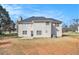 Expansive backyard view of a two-story home featuring neutral siding and multiple windows, perfect for outdoor activities at 4260 Mason Creek Rd, Winston, GA 30187