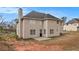 Exterior rear view of the two-story home with a chimney and spacious backyard at 4260 Mason Creek Rd, Winston, GA 30187