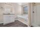 Bright bathroom featuring a soaking tub and shower stall at 4260 Mason Creek Rd, Winston, GA 30187