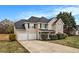 Charming two-story home featuring a two-car garage and a combination of siding and stone accents at 4260 Mason Creek Rd, Winston, GA 30187