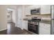 Modern kitchen featuring granite countertops, stainless steel appliances, and hardwood floors at 4260 Mason Creek Rd, Winston, GA 30187
