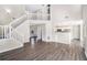 Spacious living room features hardwood floors, neutral paint colors, staircase, and pass-through to kitchen at 4260 Mason Creek Rd, Winston, GA 30187