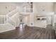 Spacious living room features hardwood floors, neutral paint colors, staircase, and pass-through to kitchen at 4260 Mason Creek Rd, Winston, GA 30187