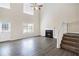 Sun-filled living room with high ceilings, fireplace, hardwood floors, and staircase to the upper level at 4260 Mason Creek Rd, Winston, GA 30187