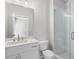 Bright bathroom featuring a white vanity with quartz countertop and a glass-enclosed shower at 175 Basil St, Cumming, GA 30040