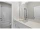 Modern bathroom showcasing white cabinets, a quartz countertop, and subway tile in the shower at 175 Basil St, Cumming, GA 30040