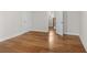Bedroom featuring hardwood floors, white trim, and an open door to the hallway at 175 Basil St, Cumming, GA 30040